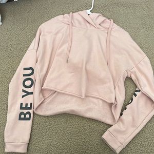 A pink crop top sweater with hoodie from Rue 21